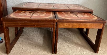 A nest of three mid 20thC tile topped tables. Largest 96cm x 48cm x 40cm h.