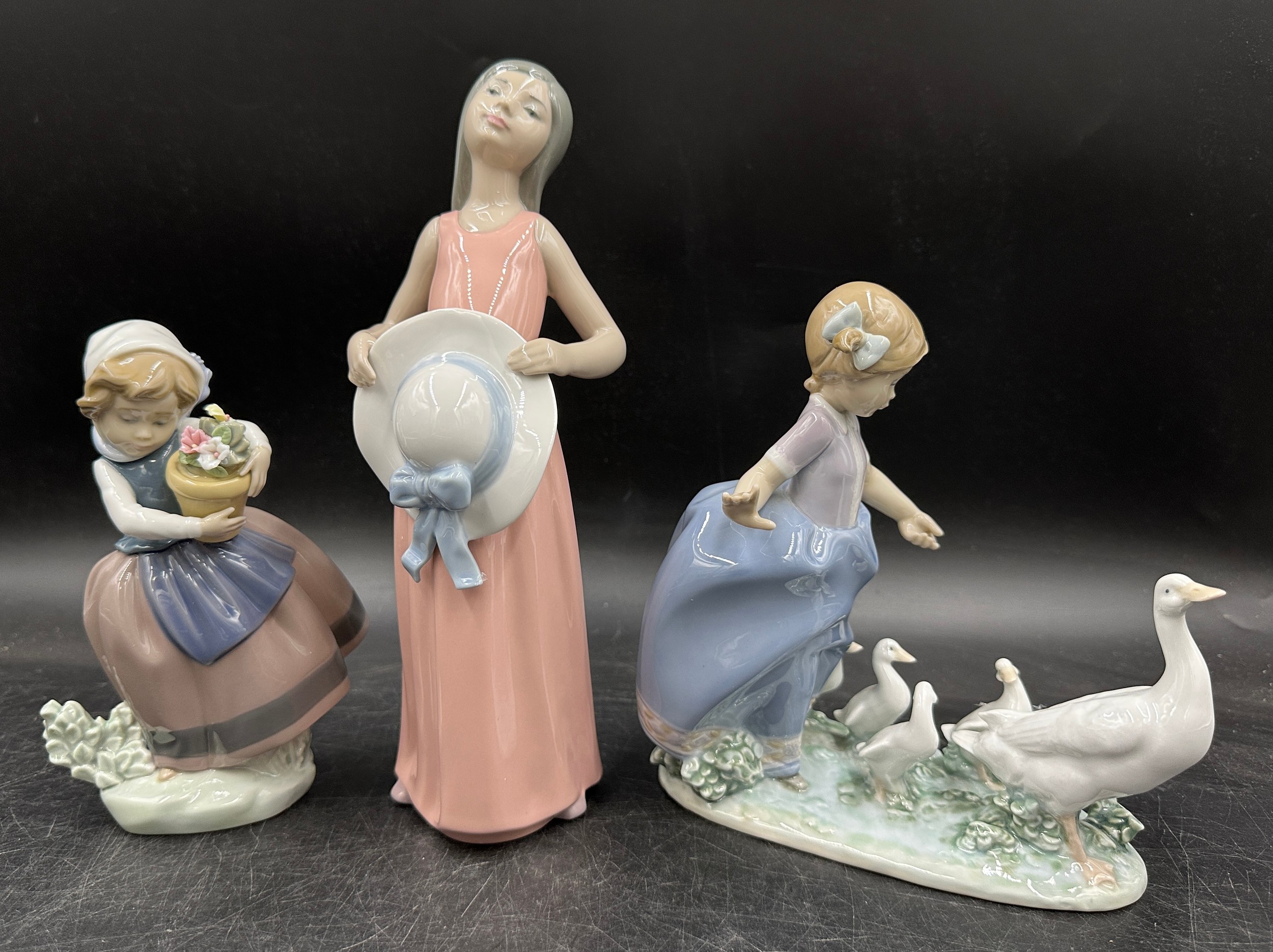Lladro figure to include 5008 ‘The Dreamer’, 25cm h. 5503 'Hurry Now' and girl with flowers.