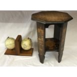 A pair of book ends with globe decoration along with a small octagonal painted table 45cm h.