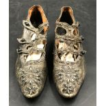 A pair of Victorian/Edwardian black leather beaded women's shoes featuring a side button fastener,