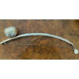 A white metal berimbau, single string musical bow originally from Africa now commonly used in