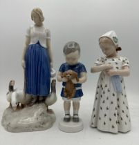 Three Royal Copenhagen figures comprising a maid standing, with three geese at her feet, on a