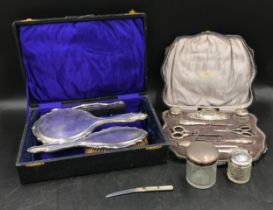 A collection of silver backed and topped items to include, a silver nine piece vanity set for