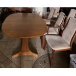 An oval extending teak G-Plan dining table and 6 chairs to include 2 carvers.