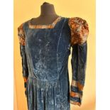 A 1920's blue velvet wrap over dress with sweetheart neck and fitted, puffed sleeves with smocking