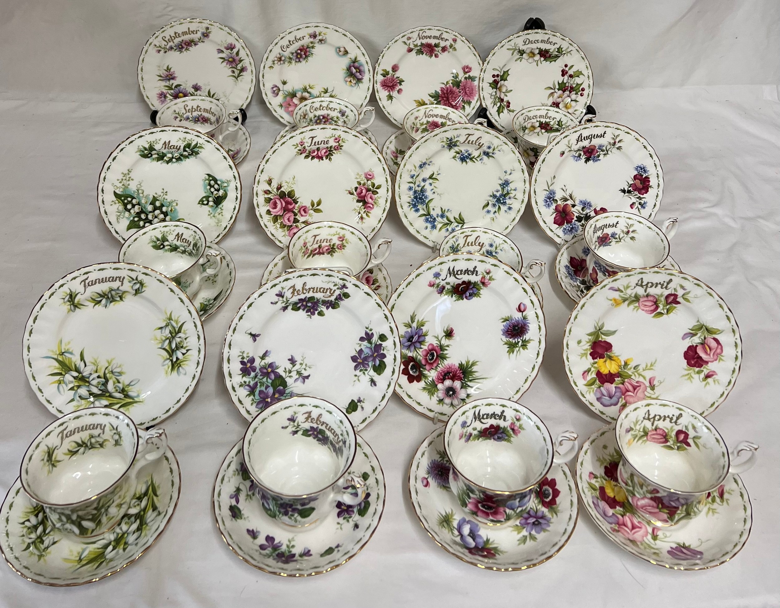 All twelve months of Royal Albert Flowers Of The Month series cups, saucers and plates, plus one