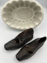 A 19thC Copeland pineapple jelly mould together with 19thC leather and wooden child’s clogs.