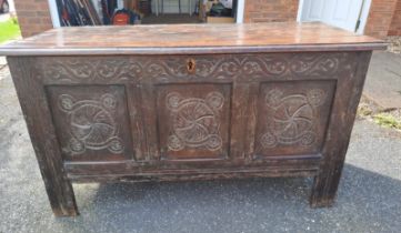 An 18thC oak panelled kist with carving to front. 72h x 130w x 58d.