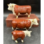 Two Beswick Ch. of Champions - Hereford Bull 10cm h and cow figurines together with a calf. All