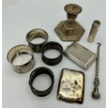 A quantity of hallmarked silver to include 4 napkin rings, various makes and dates, two vesta cases,