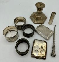 A quantity of hallmarked silver to include 4 napkin rings, various makes and dates, two vesta cases,