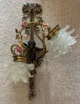 A good quality decorative brass wall light with cherub, ceramic flowers and glass shades. 54cm h.