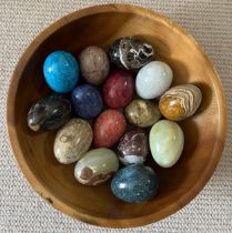 A collection of specimen polished eggs (15) presented in a wooden bowl 30 cm d to include onyx,