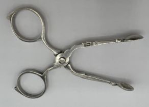 A pair of hallmarked silver sugar nips of diminutive proportions, 8cms long. Sheffield 1902 maker