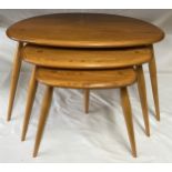 An Ercol Golden Dawn nest of three Pebble side tables largest 40.5h x 65w x 45cm d.