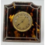 An eight day clock mounted in silver and tortoiseshell frame, London 1906. Approx. 10 x 10cm.