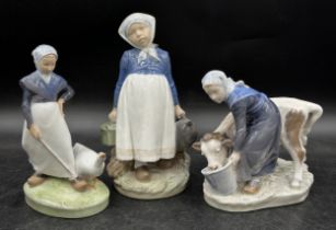 Royal Copenhagen Milkmaid Feeding Cow 779 to base, a Dutch maid 815 to base, 22cm h and a young