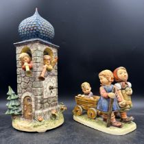 Two Goebel figurines to include, Goebel bell/clock tower with working clock featuring two