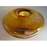 A hand blown studio amber coloured glass vase circa 1970’s. Approx. 9cm h x 15cm diameter.