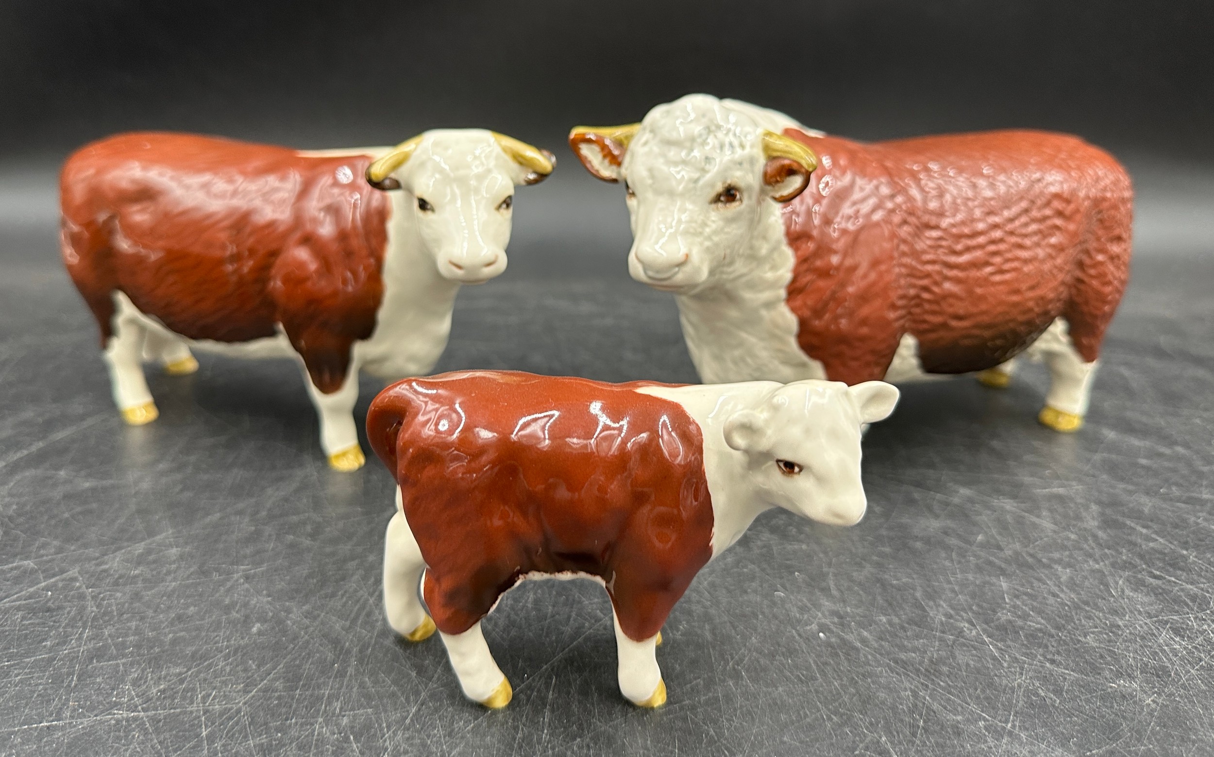 Two Beswick Ch. of Champions - Hereford Bull 10cm h and cow figurines together with a calf. All - Image 2 of 3