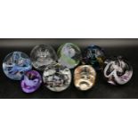 Collection of eight Caithness paper weights to include a pig, a ram's head and six other brightly