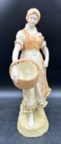 A tall Alexandra Porcelain, Austria figurine of a lady carrying a basket, model number 4982. 45cm h.