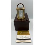 A vintage St James brass carriage clock in original box with key. 10cm h.