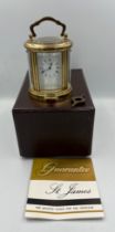 A vintage St James brass carriage clock in original box with key. 10cm h.