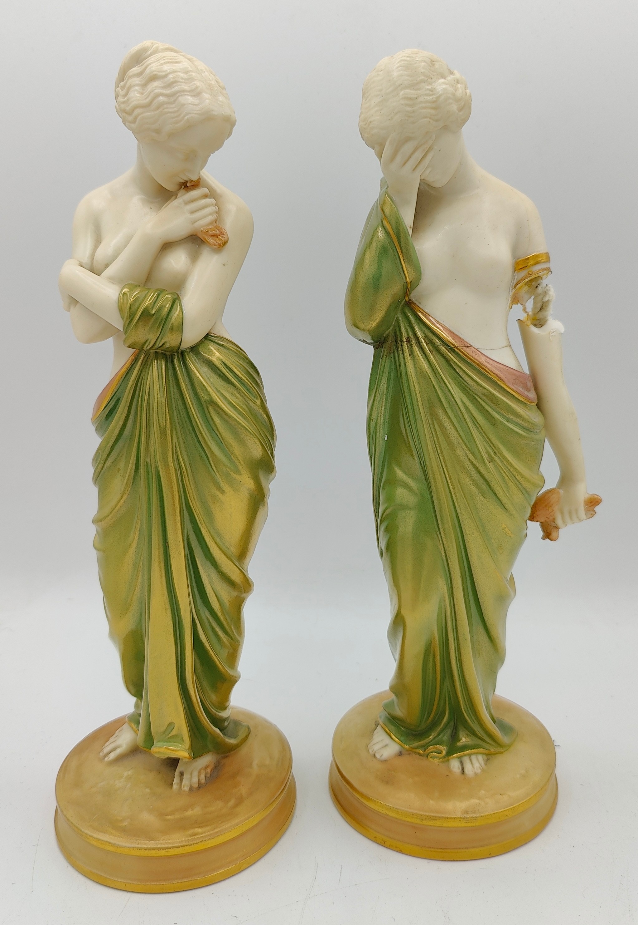 A pair of Royal Worcester figures 'Joy' and 'Sorrow' both in green and gold fabric impressed marks