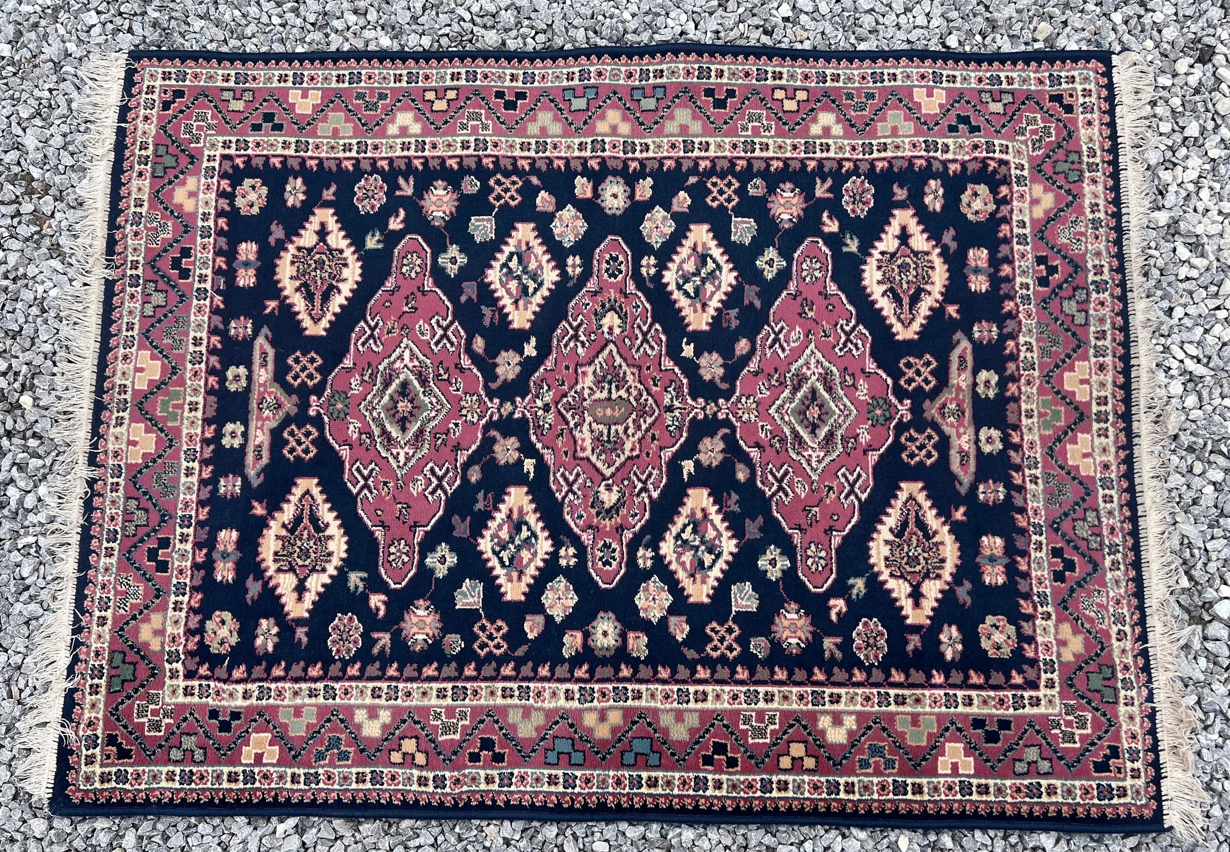 A vintage hand knotted blue/pink ground wool rug. 120 x 160cm. Possibly a Pakistan White Talim rug.