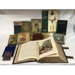 A collection of books to include, a brass bound holy Bible with metal closures and edging as well as