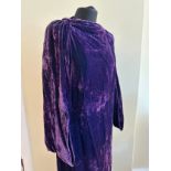 A purple crushed velvet 1920's dress/robe with three quarter length dropped, balloon sleeves.