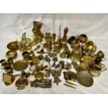 An assortment of various brass items to include door knockers, bells, boots, money boxes, bowls etc.