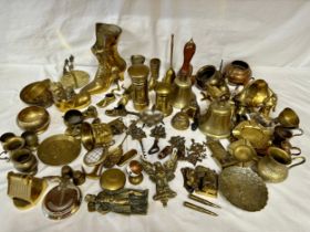 An assortment of various brass items to include door knockers, bells, boots, money boxes, bowls etc.