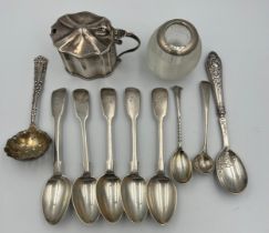 A quantity of hallmarked silver spoons, various dates and makers, a mustard pot with blue glass