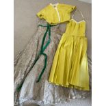 Two 1950's dresses, a strapless cream lace evening dress with petticoats and green bow detail