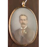 A Victorian miniature portrait, painted by A. James, 1897, of a gentleman in a tie in gilt frame, on