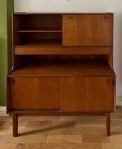 A mid 20thC teak unit comprising two cupboards, two drawers and a drinks cabinet. 122cm w x 44cm d x