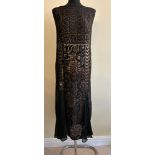 A 1920s cocktail sleeveless dress black, brown and gold tones, with four black inserts. Shoulder