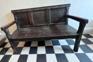 A mainly 18thC oak settle. With fitted cushion in hunting pattern. 116cm w x 74cm w. Height to