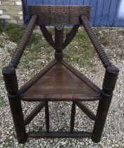 Oak carved back Turners chair, bubble turned arms, circular legs. Height to seat 47cm,