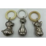 Three contemporary silver plated baby rattles with teething rings, a dog, a cat and a koala bear.