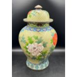 A large Cloisonné green jar and lid decorated with coloured flowers, birds, foliage etc measuring