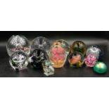 Collection of 12 glass paperweights of varying colours, shapes and sizes, tallest approx 14cm, one