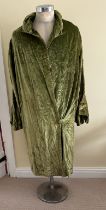 A 1920's ladies green velvet wrap robe with single covered button to the front, full length ruched