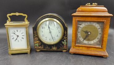 A collection of three clocks to include, a Walker & Hall ltd black lacquered mantle clock with