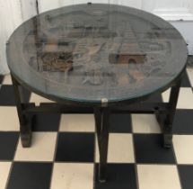 Occasional wooden carved table 60cm diameter, 40cm h with a glass top.