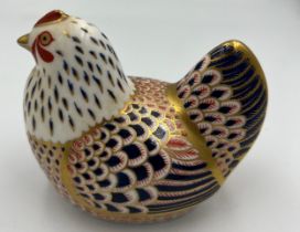 A Royal Crown Derby Imari chicken paperweight with gold stopper.