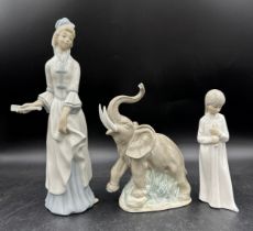 Two Nao figurines by Lladro, an elephant 22cm h, a young girl together with another similar unmarked