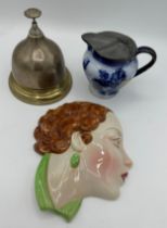 A miscellany to include a counter top brass bell 12.5cm h, a ceramic wall plaque 17.5cm l and a